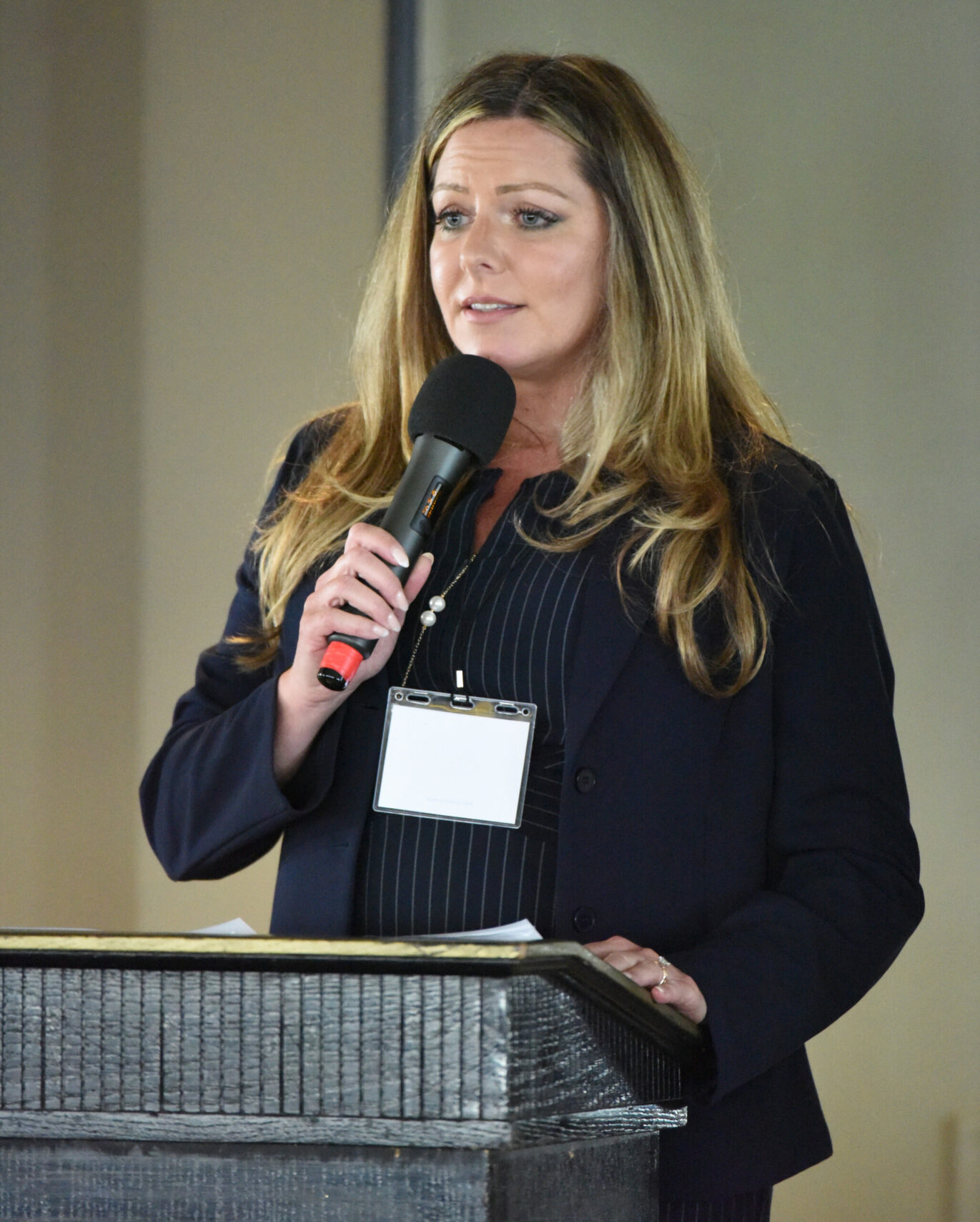 A woman speaker honoring an inductee at a Distinguished Lawyer Memorial Celebration.