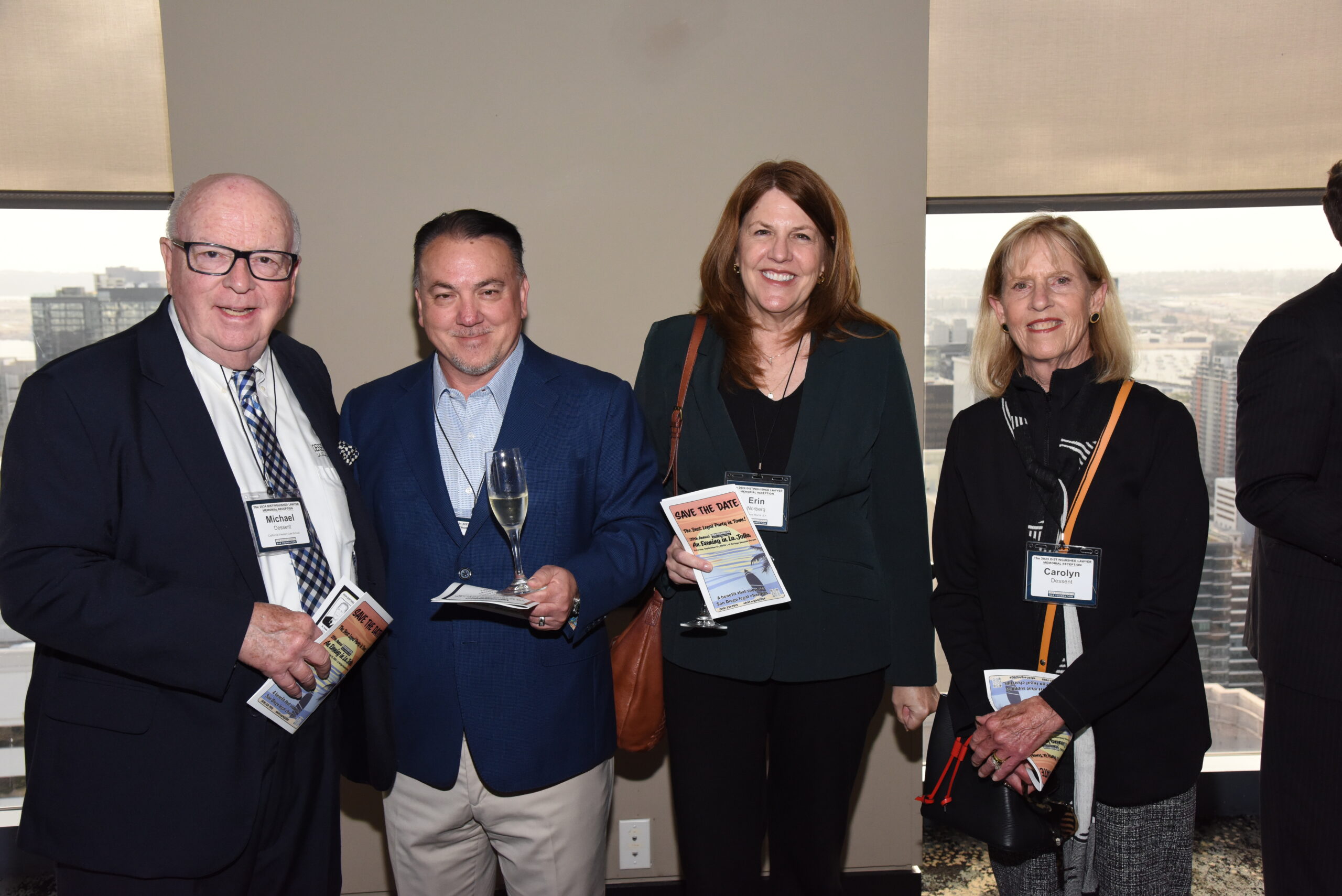 Family members at a Distinguished Lawyer Memorial Celebration receiving a certificate honoring their deceased loved one.