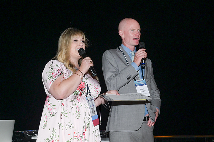 Man & woman award recipients speaking at Evening in La Jolla 2024 event.